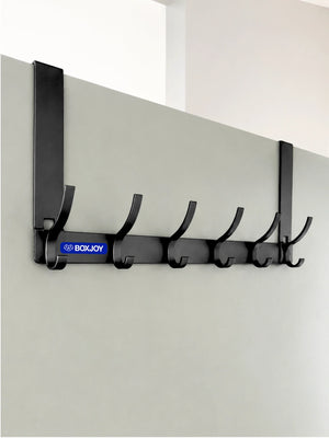 Grey BOXJOY over-the-door metal hanger with six rounded hooks mounted on a white door.