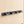 Grey BOXJOY wall-mounted broom and mop holder with four grips and five hooks installed on a tiled wall.