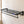 Black BOXJOY wall-mounted bathroom shelfs with a lower towel bar and hooks installed on a tiled wall