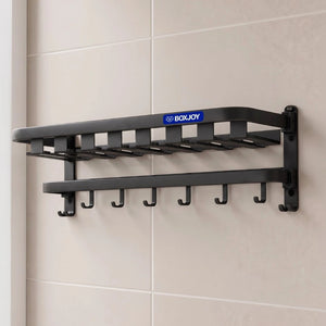 Black BOXJOY wall-mounted bathroom shelfs with lower hanging hooks installed on a tiled wall.
