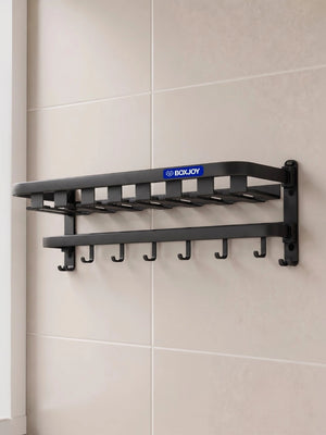 Black BOXJOY wall-mounted bathroom shelfs with lower hanging hooks installed on a tiled wall.