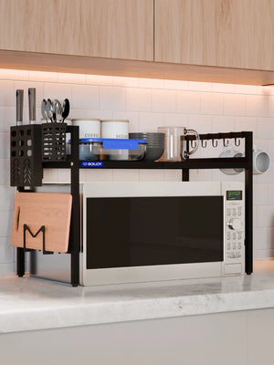 Black BOXJOY microwave shelfs holding kitchen accessories and hanging mugs above a microwave.