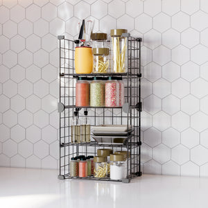 Fully organized BOXJOY 4-tier black metal wire kitchen rack filled with spice jars, oil bottles, and pasta containers.