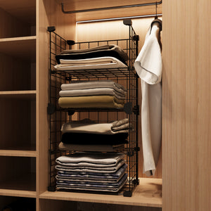 Fully organized BOXJOY 4-tier black metal wire closet storage rack placed inside a wooden wardrobe filled with folded clothes.