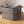 Four grey BOXJOY stackable fabric storage boxes filled with folded clothes on a wooden floor.
