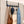 Grey BOXJOY over-the-door hook hanger holding a scarf, bags, a hat, keys, and a denim jacket.