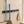 Grey BOXJOY wall-mounted organizer holding a squeegee, a broom, and a hanging towel on a tiled wall.