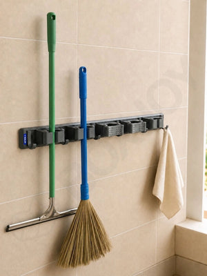 Grey BOXJOY wall-mounted organizer holding a squeegee, a broom, and a hanging towel on a tiled wall.