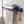 Black BOXJOY bathroom shelfs holding folded towels and a hanging wooden body brush.