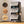 Detail view of the 6 black modular shelfs with smoky transparent doors, featuring circular close-ups of feet, hooks, and a mallet.