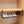 Black BOXJOY under-cabinet hanging shelfs holding four pairs of shoes.