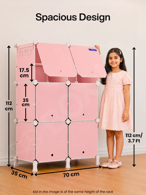 Spacious design of the BOXJOY Plastic 12 Shelf Pink Kids Wardrobe next to a 112 cm tall girl.