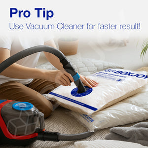 Pro tip showing a person using a vacuum cleaner on a BOXJOY storage bag for faster compression.