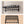 Dimensions of the bathroom shelfs showing 57 cm width, 18 cm height, and included mounting hardware.