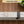 Top-down view showing the grey bracket easily fitting on a door with a 4.5 cm maximum width next to a coin.