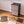 Easy to assemble black modular wardrobe with 8 shelfs shown partially built next to a mallet.