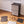 Easy to assemble black modular wardrobe with 10 shelfs shown partially built next to a mallet.