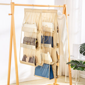 Beige hanging organizer with multiple pockets holding various handbags on a wooden rack.