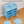 Smiling boy playing with a toy shuttle next to his BOXJOY Plastic 12 Shelf Blue Kids Wardrobe.