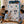 Smiling family watching a boy point at astronaut stickers decorating his blue wardrobe with 7 shelfs.