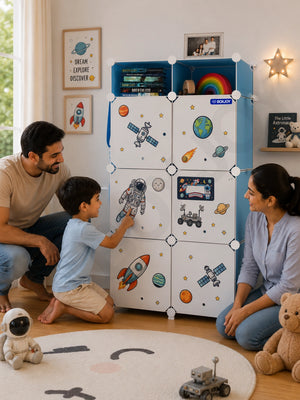 Smiling family watching a boy point at astronaut stickers decorating his blue wardrobe with 7 shelfs.